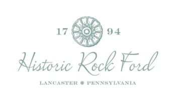 Logo For Historic Rock Ford Featuring A Floral Design, The Year 1794, And The Text “Historic Rock Ford” In Script, With “Lancaster, Pennsylvania” Printed Below In All Caps.